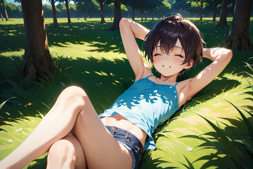 Boy lying on the grass in a summer park