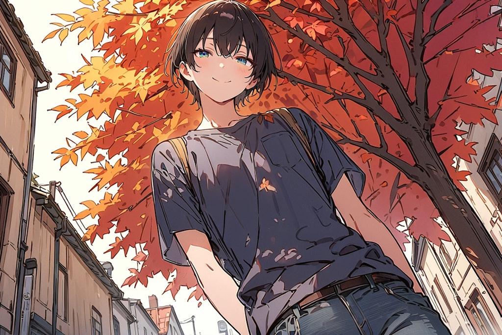 A young man under the trees on a street in autumn