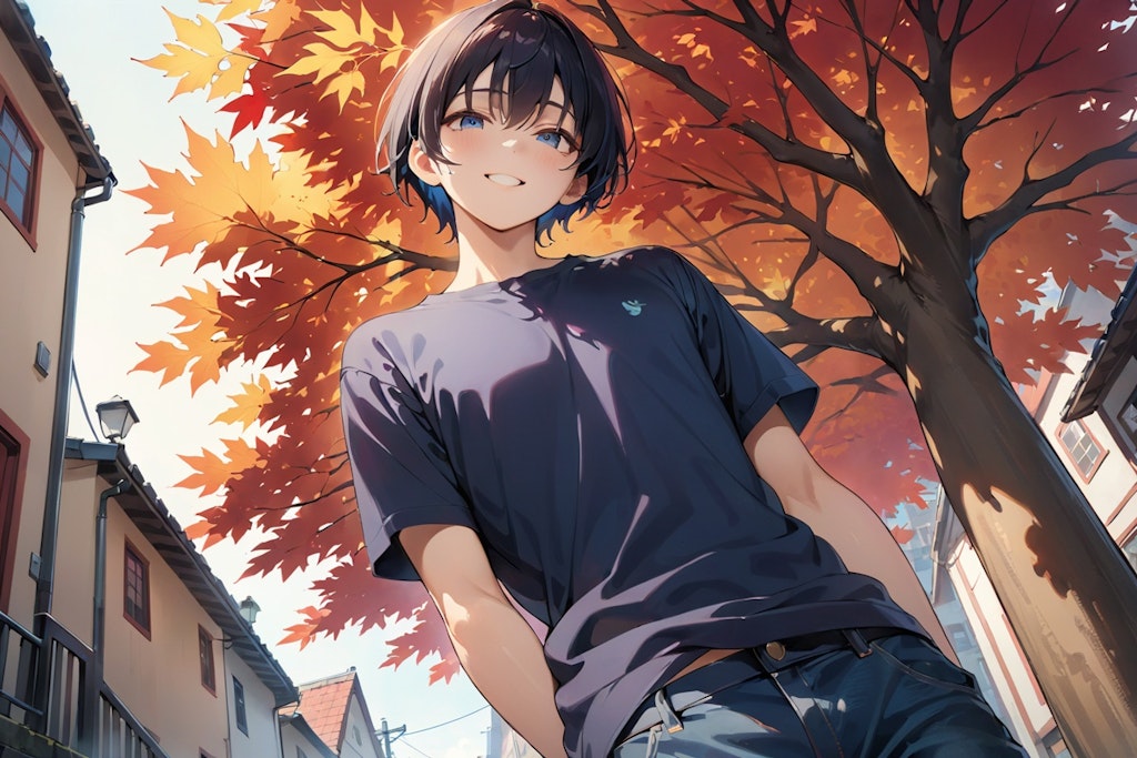 A young man under the trees on a street in autumn